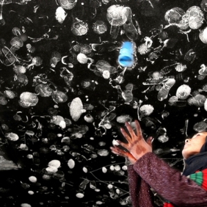 Farzana Wahidy, Making an impression. An Afghan girl throws her shoes upward to a ceiling littered with other footwear