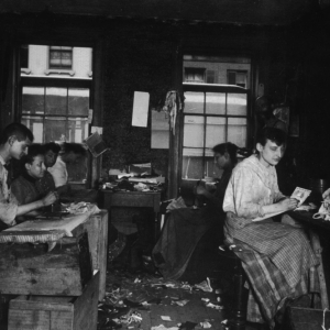 Jacob Riis, Men and women make neckties inside a tenement on Division Street, photograph, Italy, circa1890.